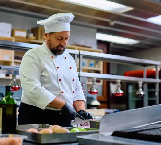 Kitchen and Property Coverage for Restaurants Chef preparing food in commercial kitchen