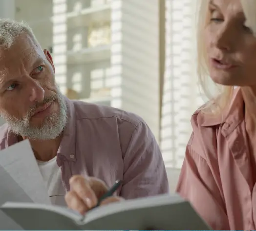 Plan Ahead with Confidence Couple reviewing life insurance policy